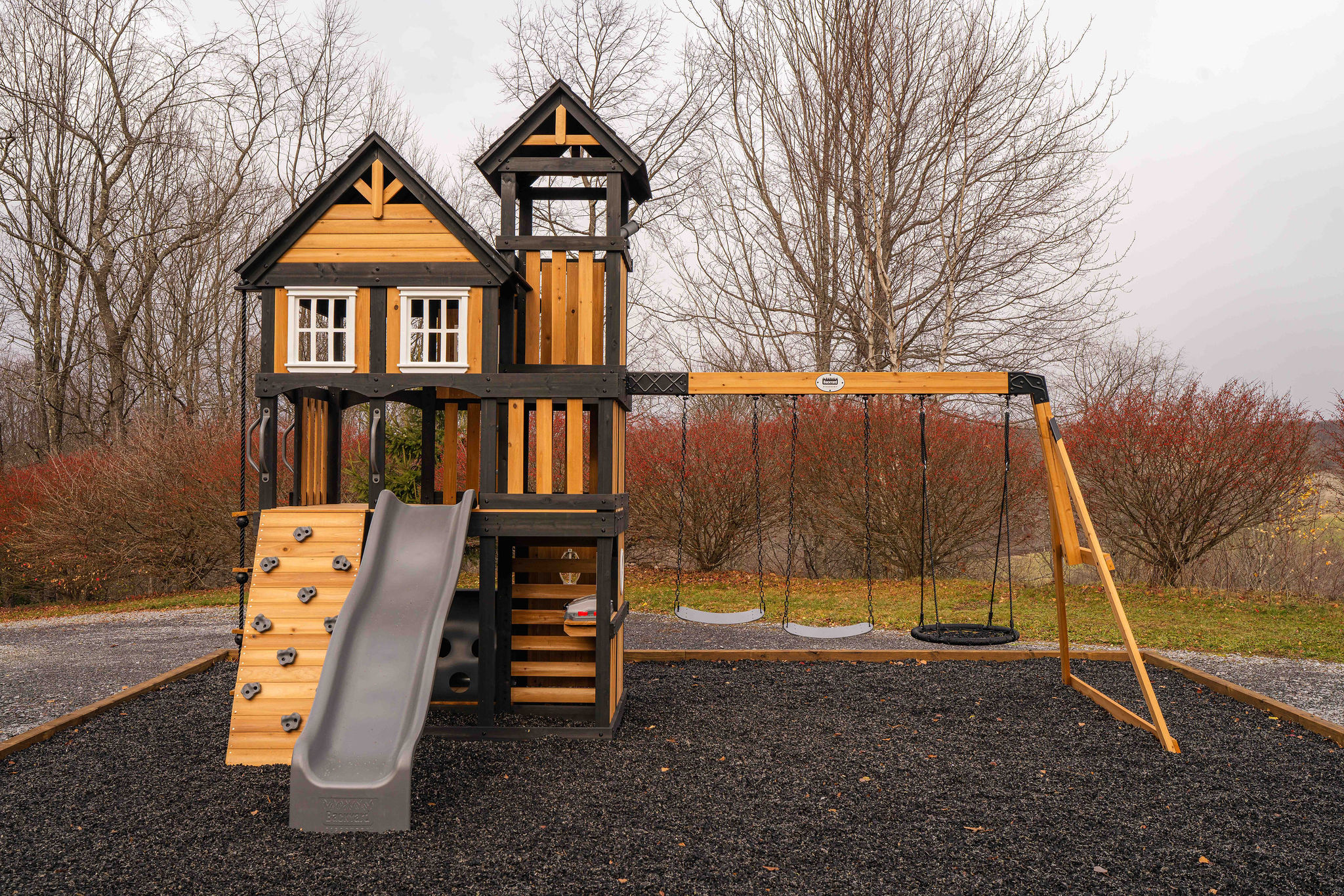 Kids’ swingset and play tower with slide, swings, and climbing wall