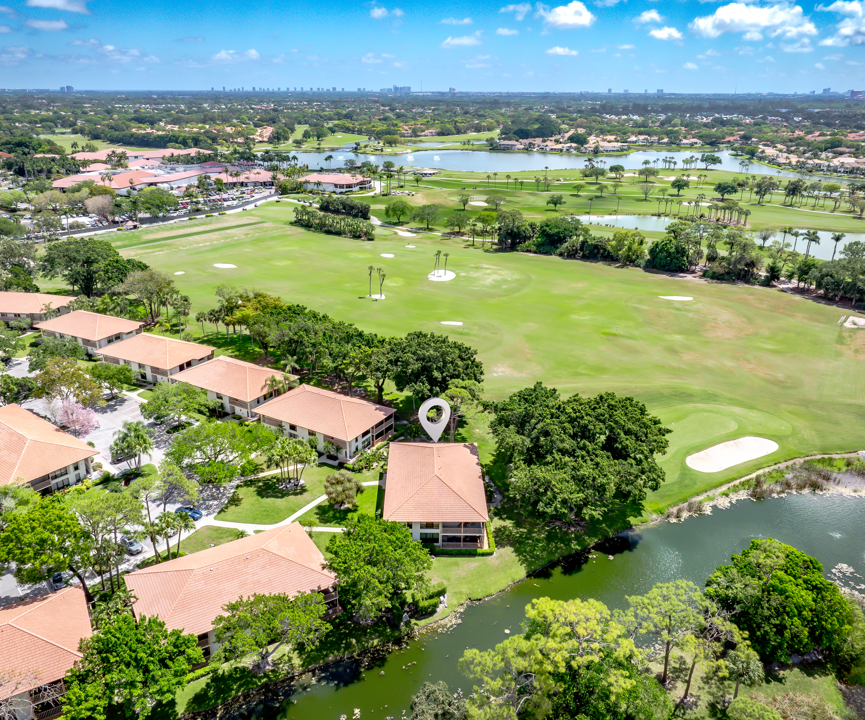 Aerial view showcasing lush golf course, water features, and serene surroundings