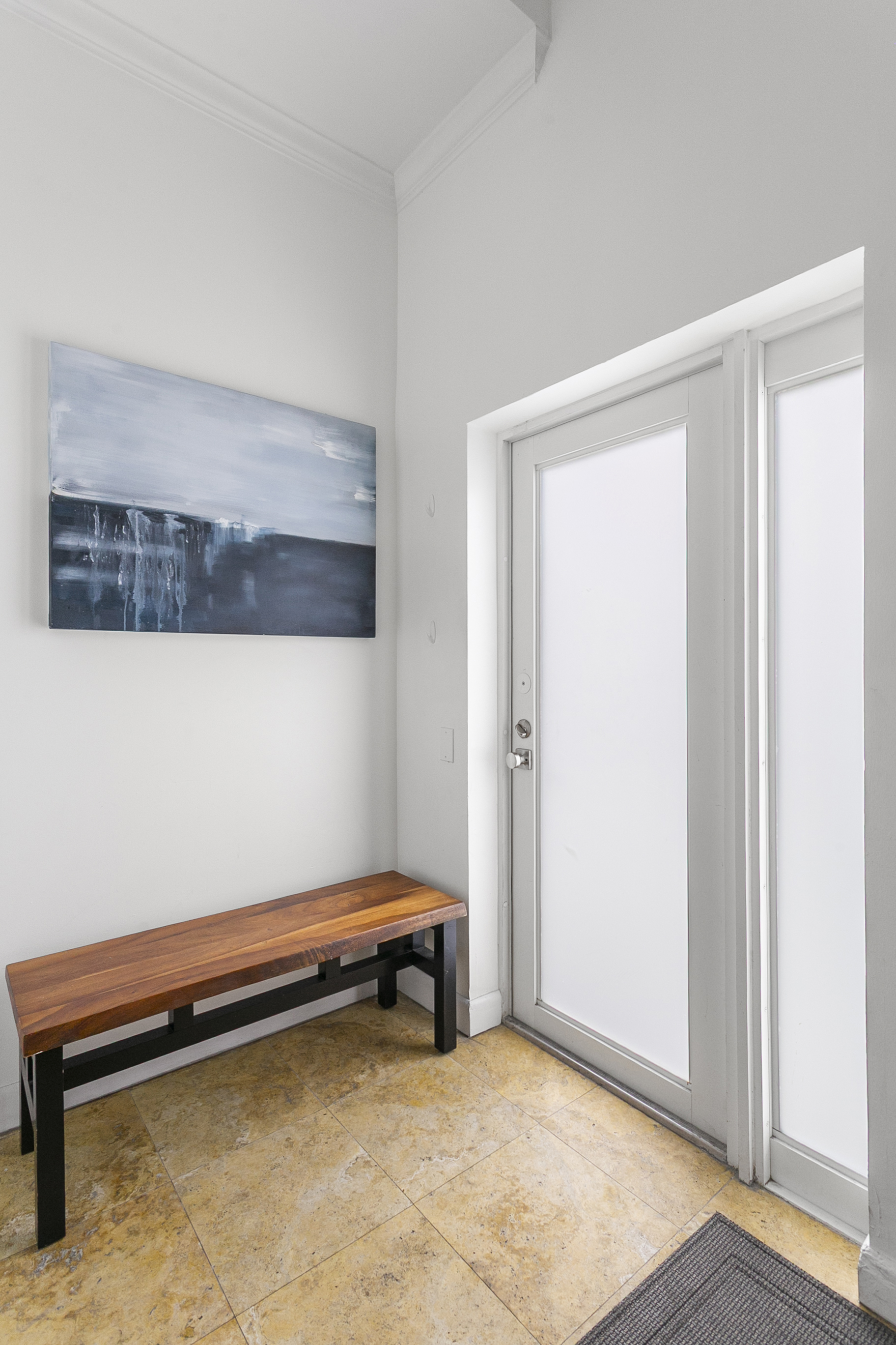 Private entrance foyer with storage space, easily accessible beach gear, and a bench
