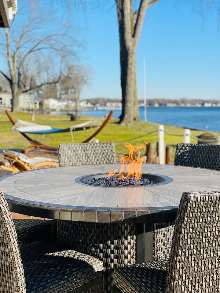 Outdoor fire pit table perfect for relaxing evening by the lake.