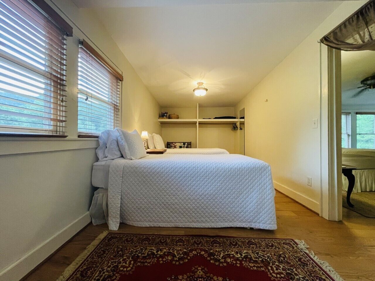 A privacy curtain is installed in the doorway between these spaces