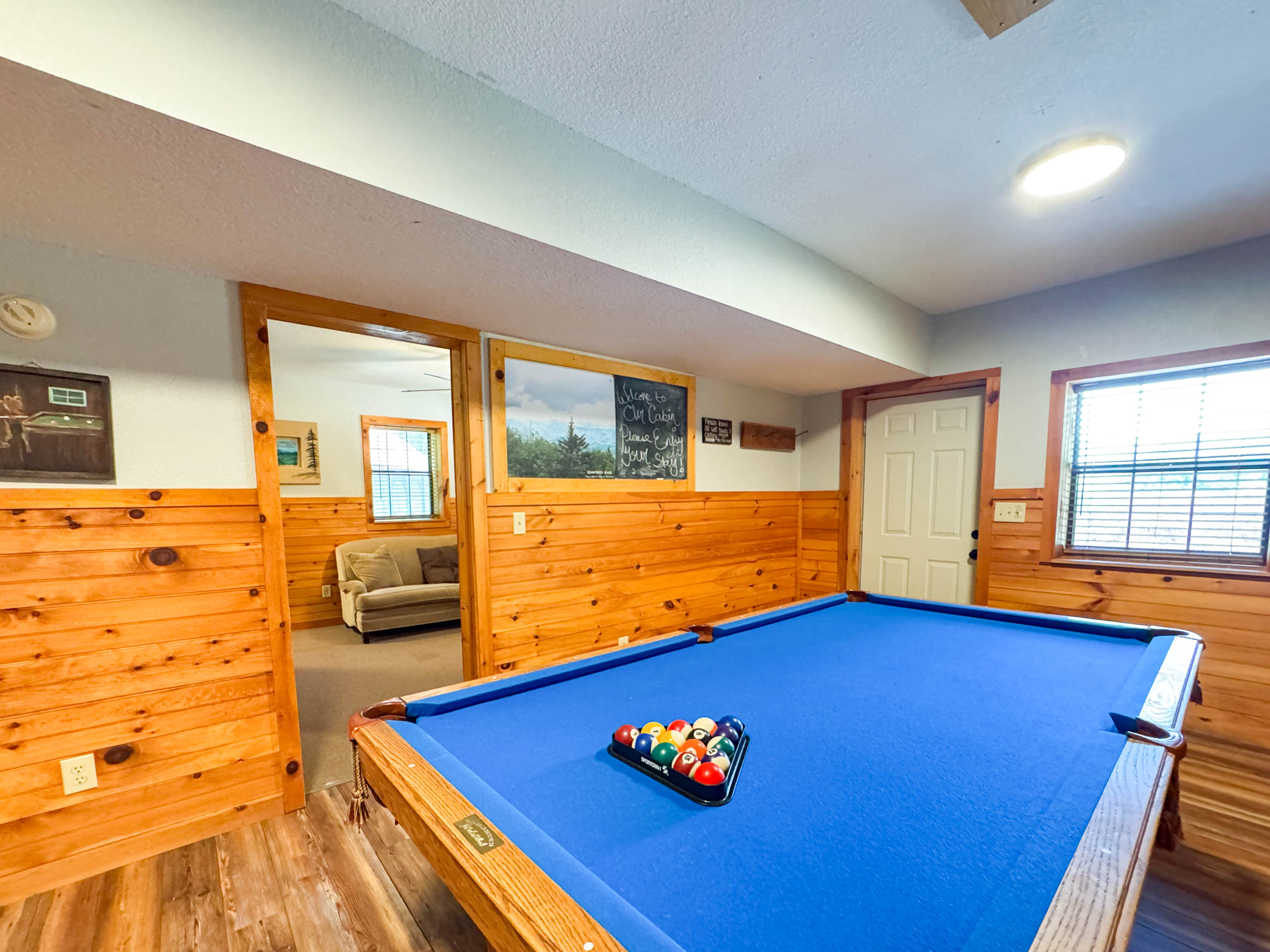 the lower level game room features a pool table and card table