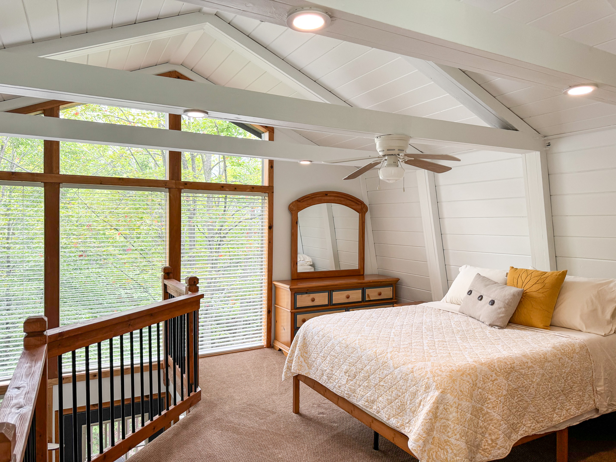 Primary loft bedroom with attached bathroom