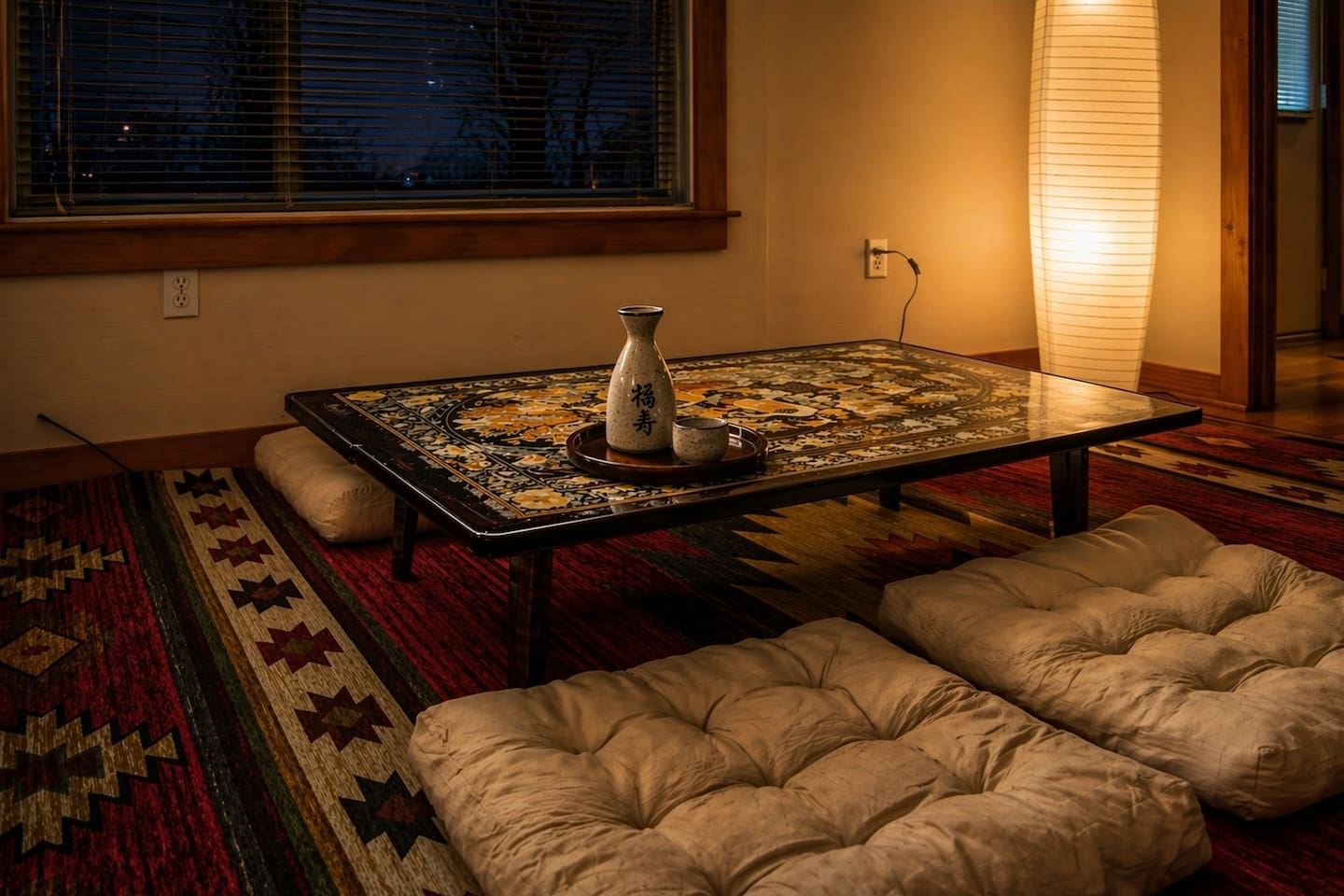 Relax in a Japanese-style living room with a low table, floor seating cushions, and warm, calming design—perfect for tea, conversation, or quiet moments, blending comfort and culture into a unique, peaceful retreat experience