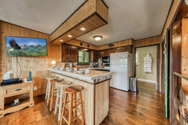 Make yourself at home in the kitchen, featuring a spacious counter, refrigerator, and all the essential amenities to prepare your favorite meals with ease