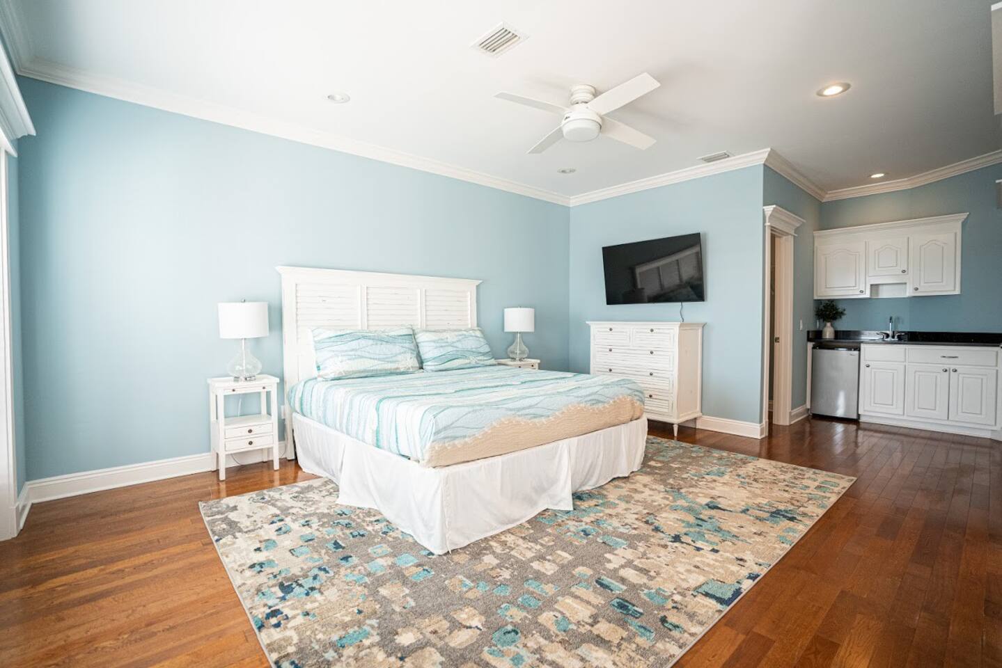 Another view of the master bedroom showing private kitchenette and walk in closet.
