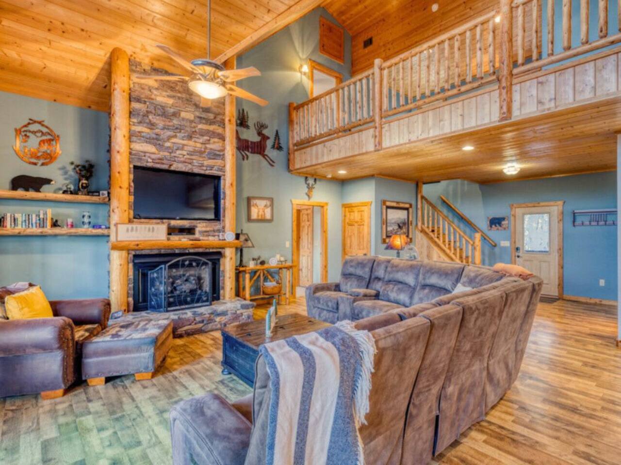 Relax in our cozy living room, complete with comfortable couches, chairs, a crackling fireplace, and a TV for your entertainment.