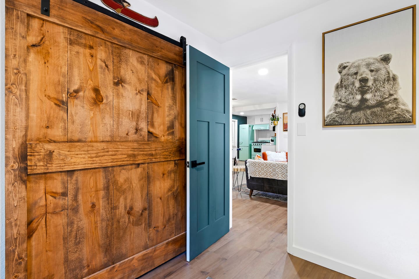 Gorgeous customer barn doors conceal the closet.