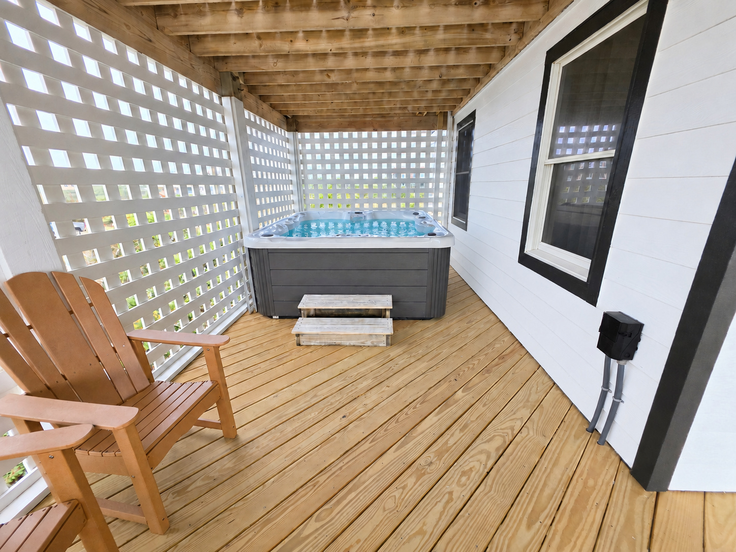 Hot tub tucked away in a private corner of the mid level deck with ocean views. 