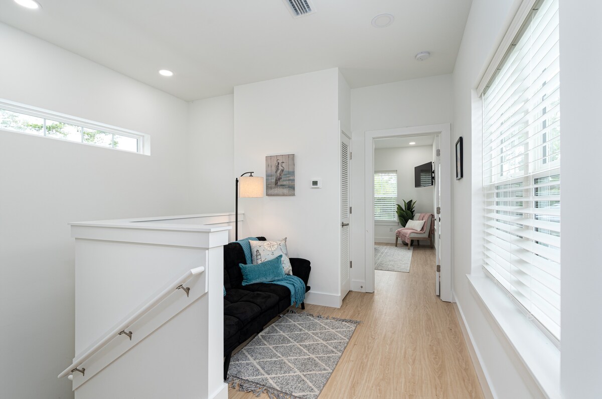 The landing at the top of the stairs became a room of its own - a futon, a lamp, a rug and a view down the hall. Somebody always ends up here with a book while the rest of the house is still out in the pool.