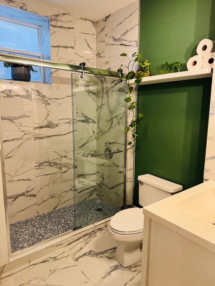 Bathroom with glass shower and modern tile design.