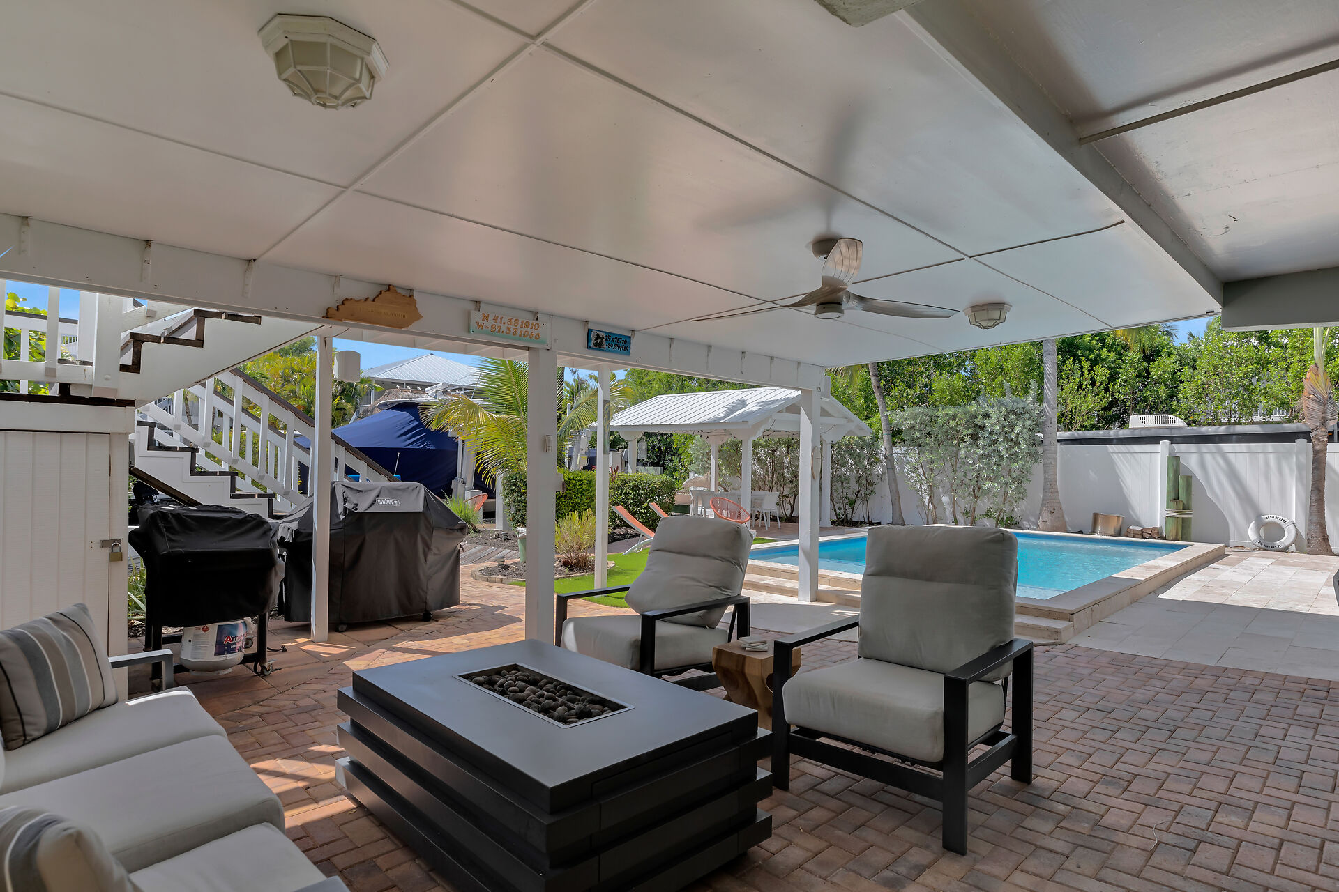 Downstairs covered lounge area with fire table