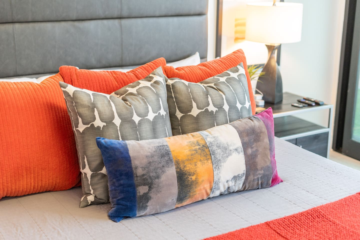A close-up look at the king bed’s vibrant pillows and luxurious textures, curated for both comfort and visual delight.

