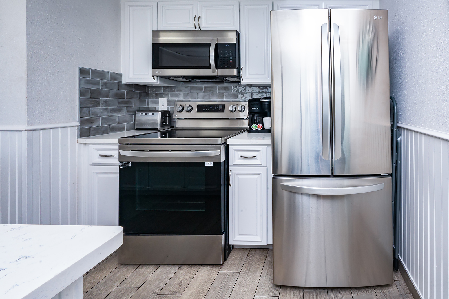 New stainless steel appliances and white cabinets