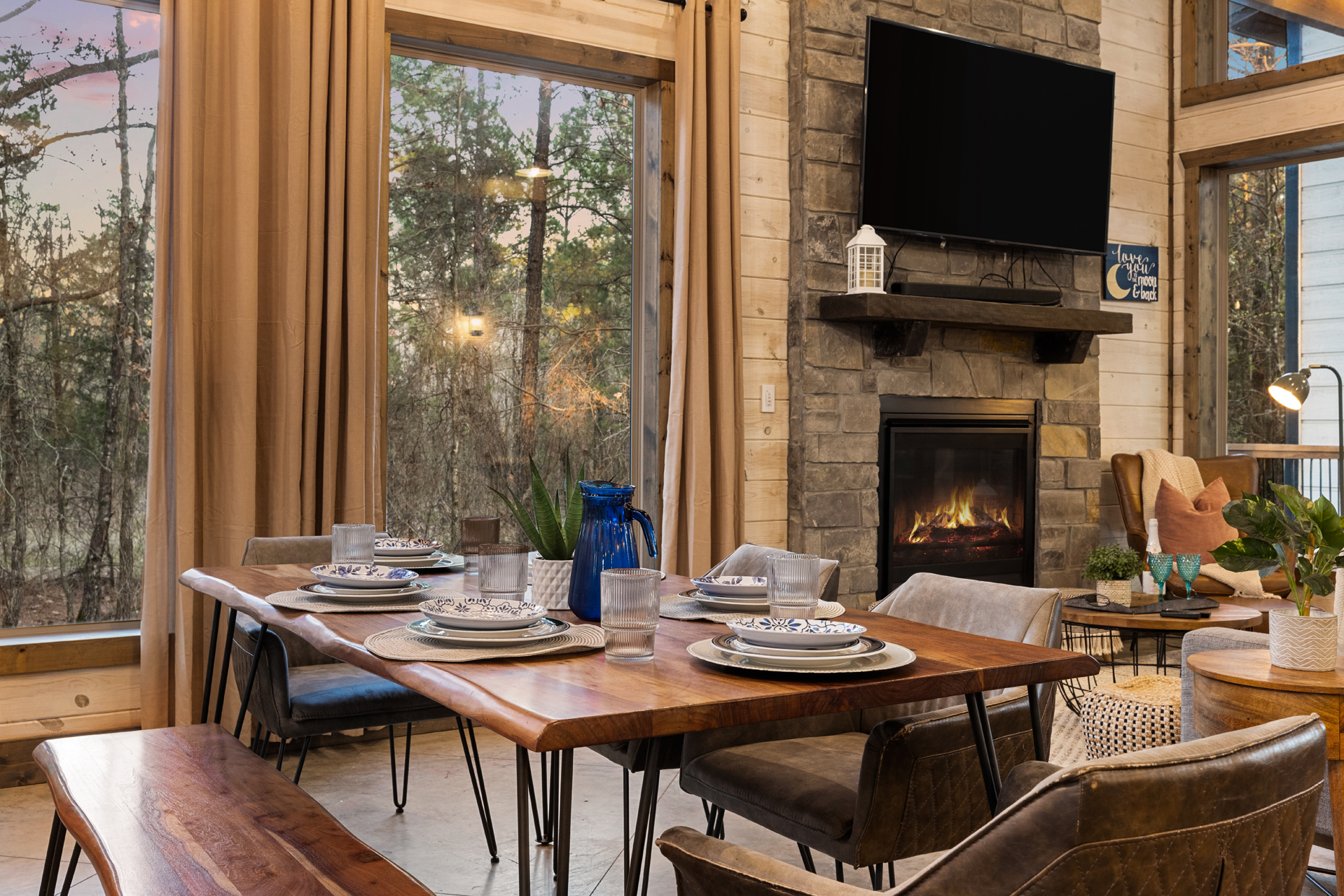 Invite everyone to linger a little longer. Soft lighting, a crackling fire, and a roomy dining table create the scene for long dinners, card games, and easy conversation late into the evening.