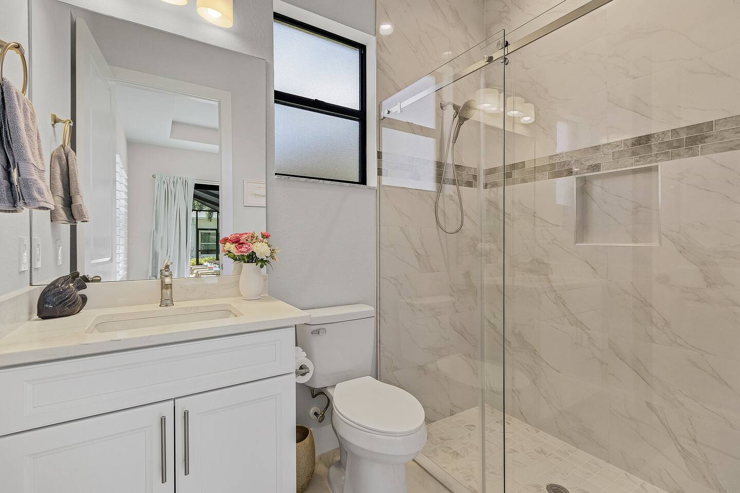 Second ensuite bathroom featuring a sleek vanity and walk-in shower, designed for your comfort and convenience.