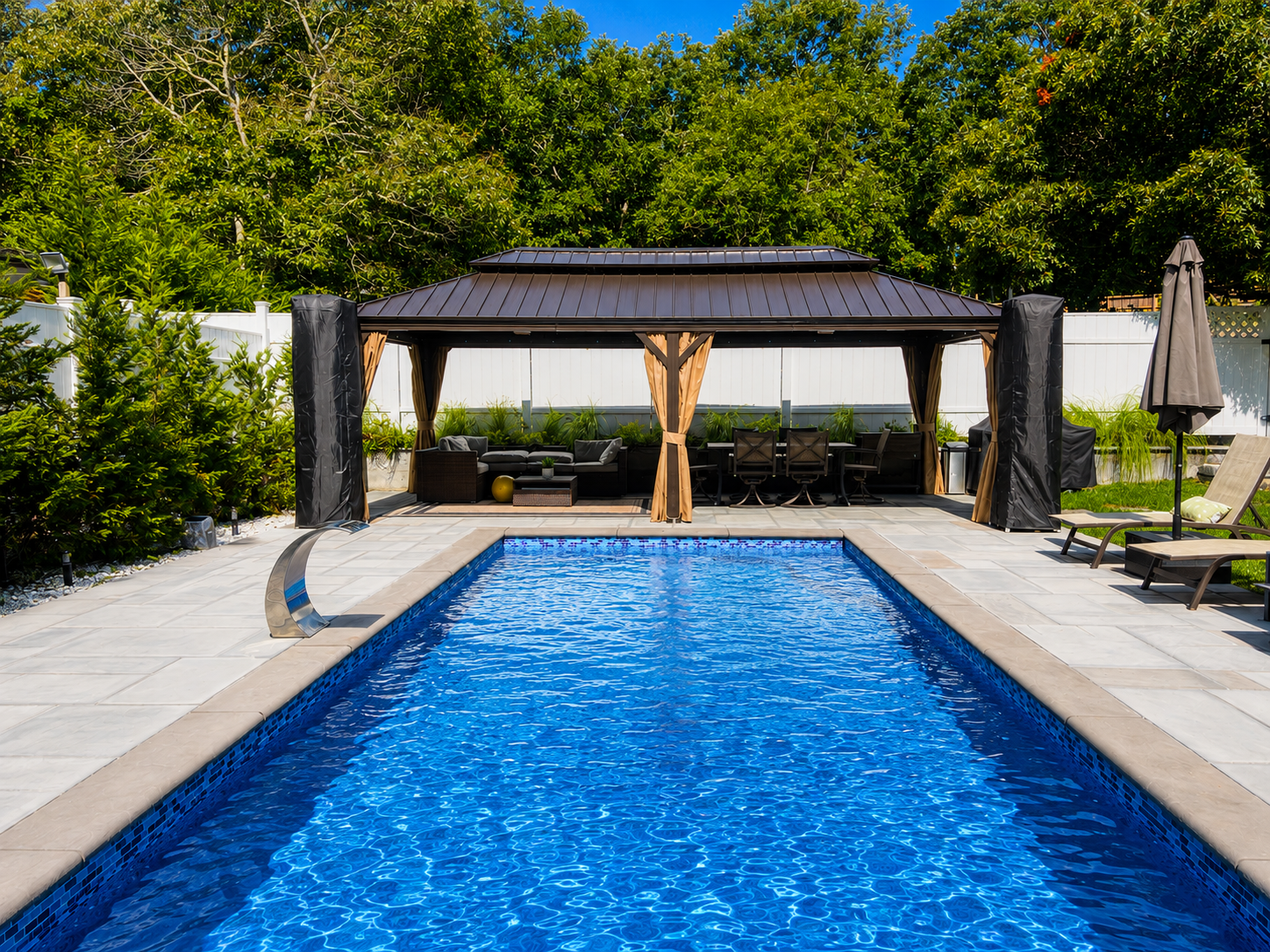 Sparkling heated pool framed by the shaded gazebo seating area