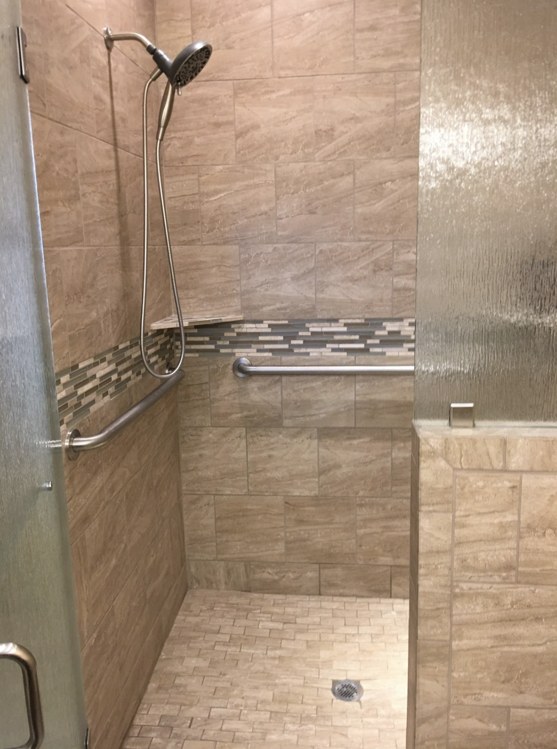 The Handicap-Accessible shower in the primary bedroom