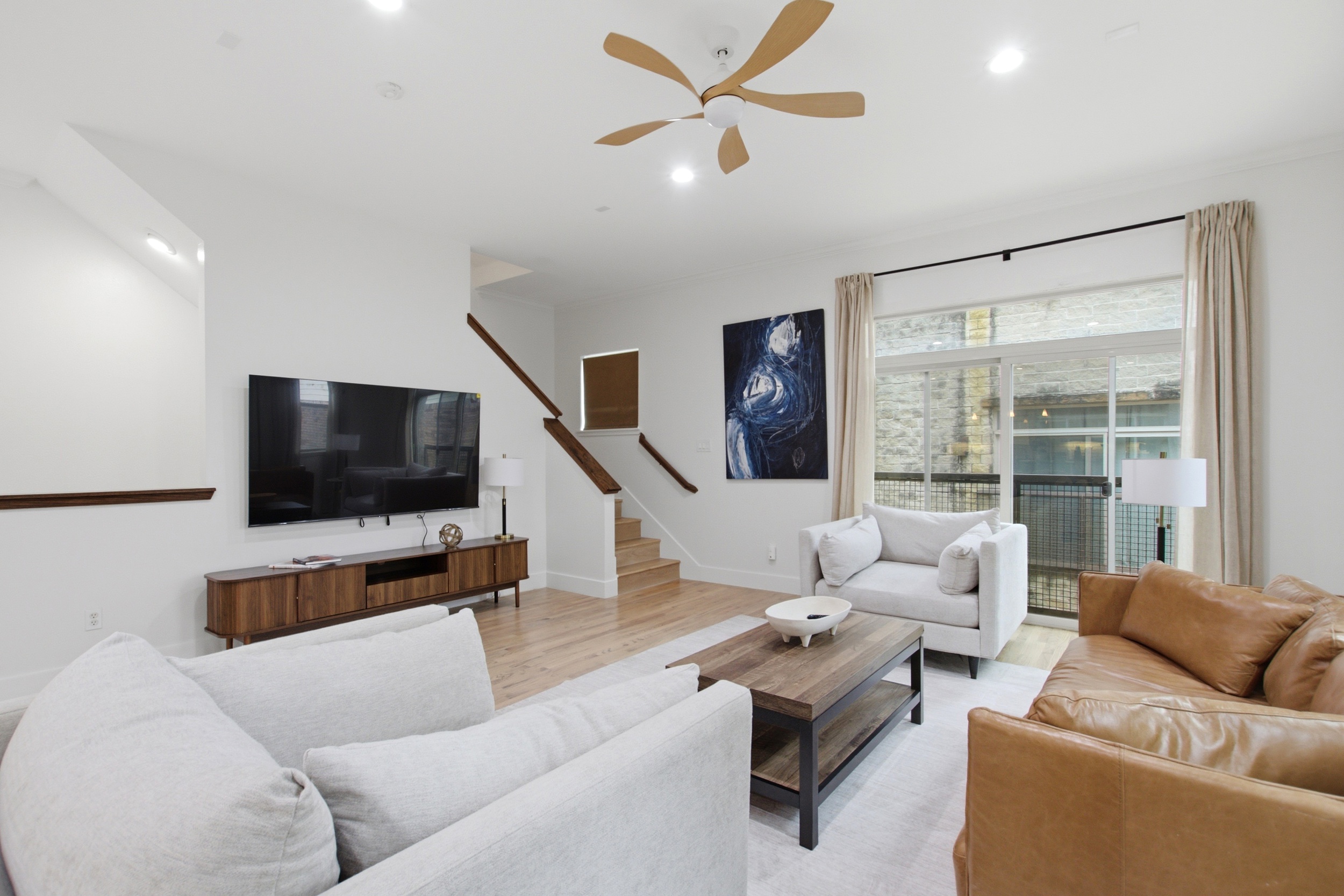 Stylish space with sleek furniture and vibrant art, perfect for unwinding and enjoying!