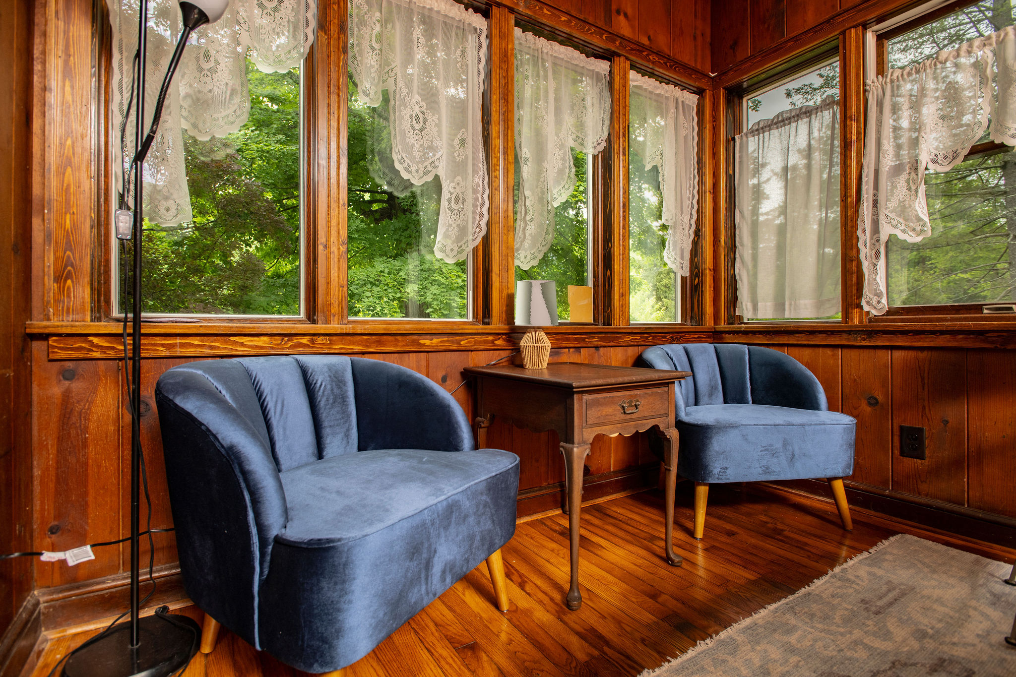 Reading nook with velvet chairs, perfect for morning coffee among the trees