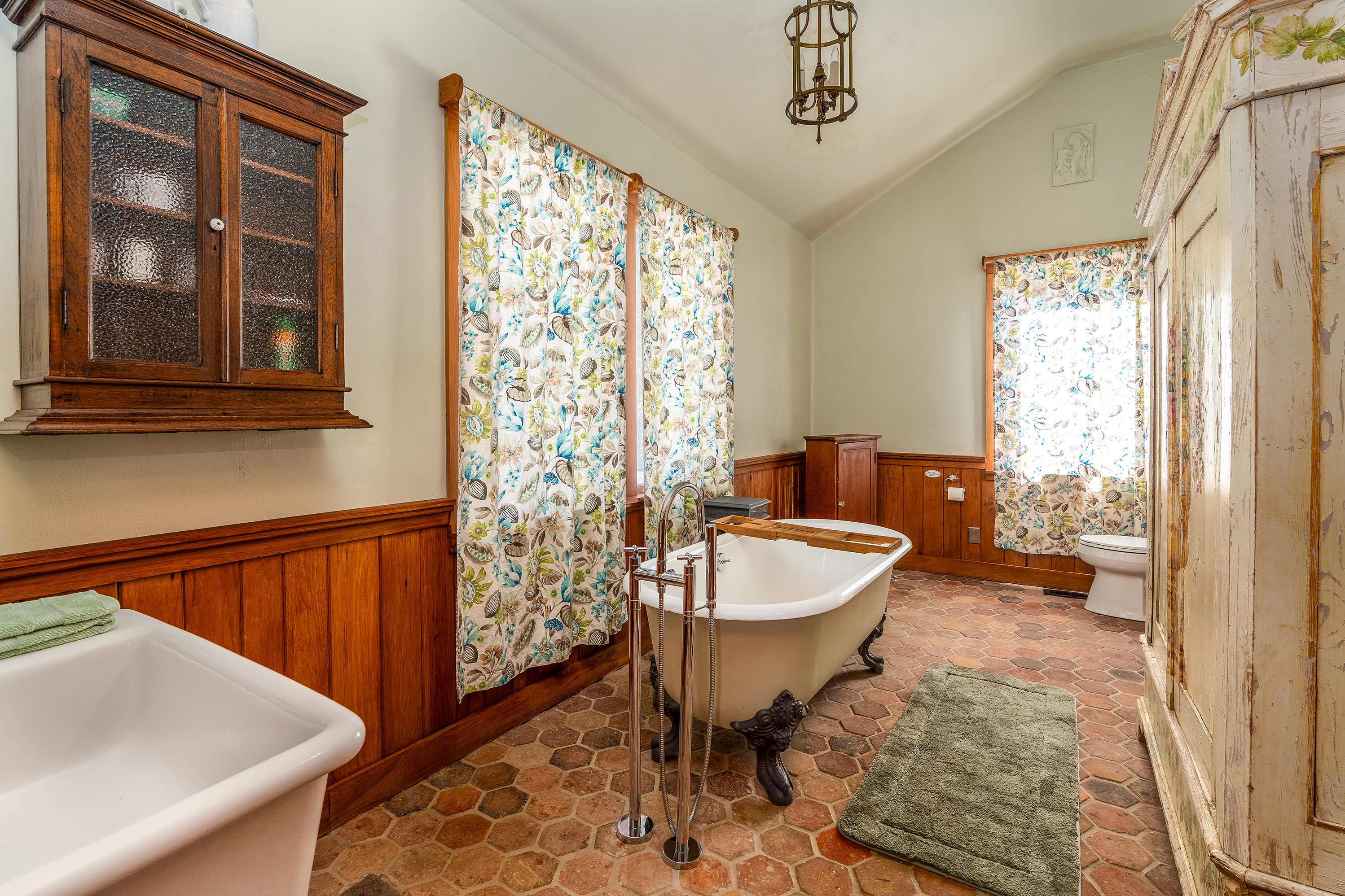 Elegant bathroom featuring a classic clawfoot tub and unique Italian Cesame sink.