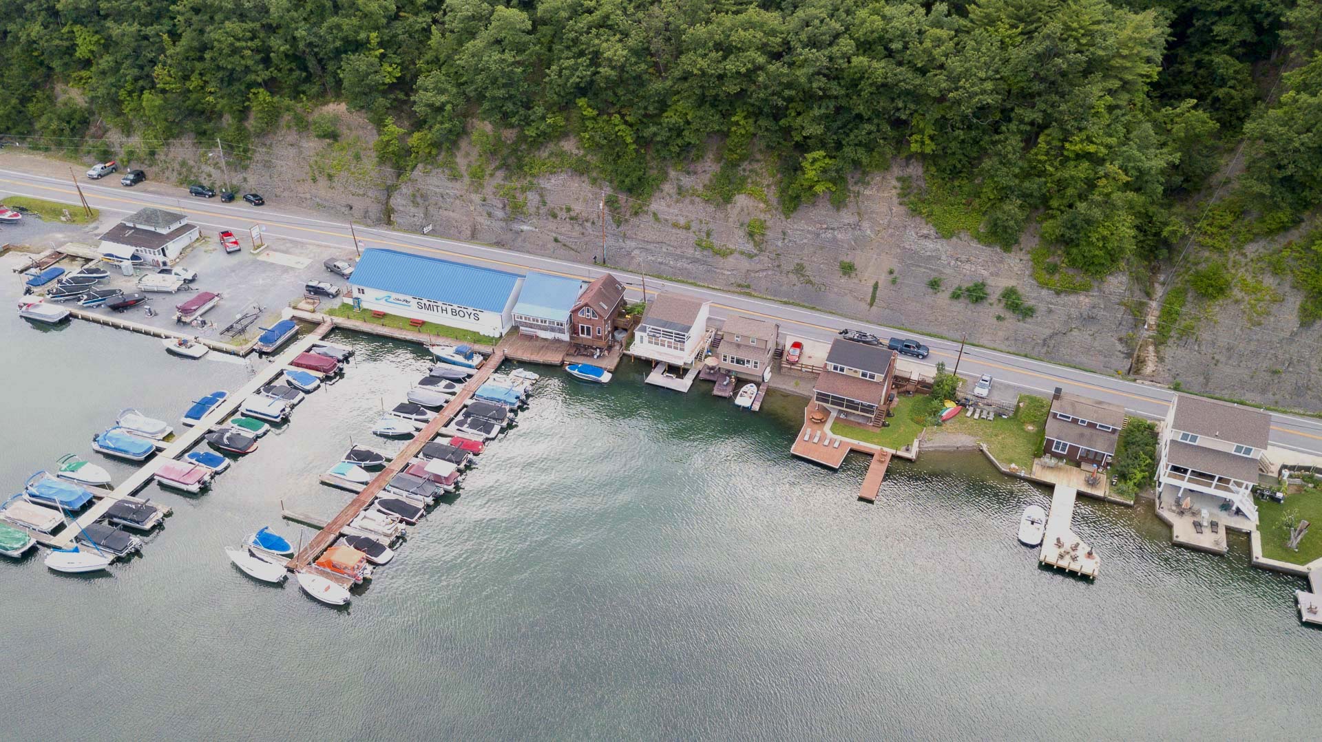 Nestled at the edge of a serene lake, this charming dock features a row of inviting, comfortable chairs, perfect for relaxing and enjoying the peaceful surroundings. The chairs, crafted from weather-resistant materials, are designed for comfort with 