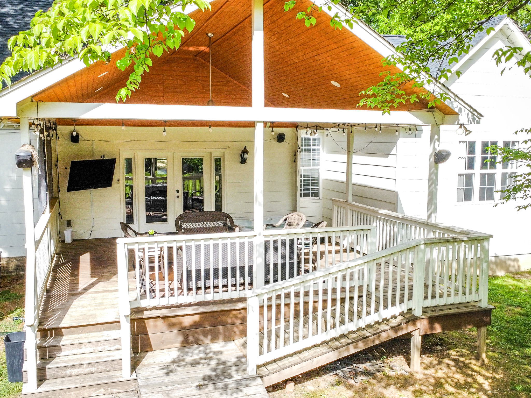 Covered deck with hot tub and TV