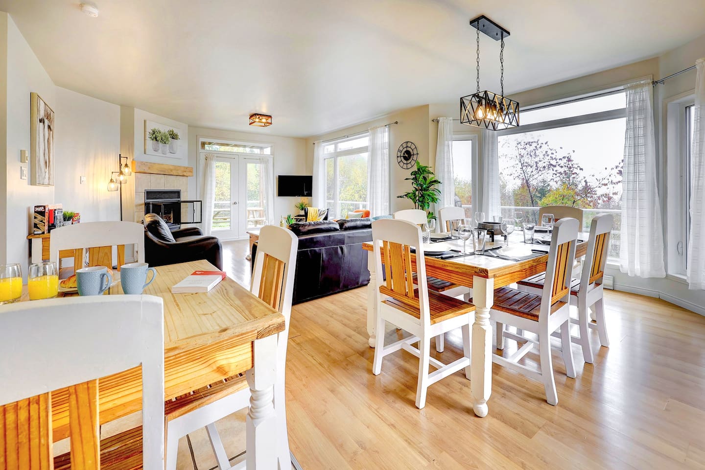 Two dining tables create a versatile space for meals and gatherings.