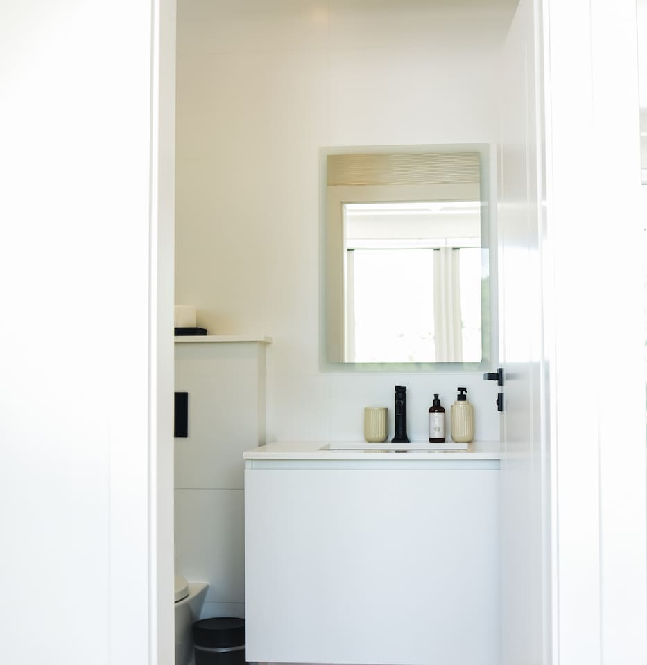 Master bedroom’s en-suite bathroom - stocked with premium toiletries from local artisan Neem Avenue, including shampoo, conditioner, and body wash.