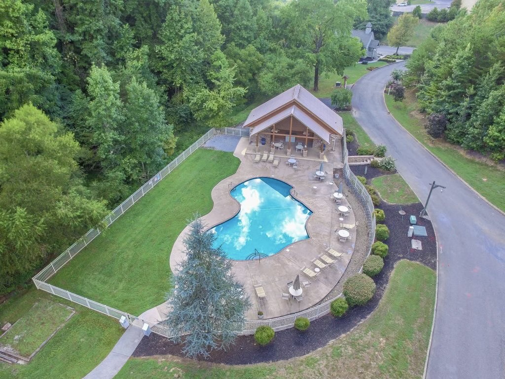 A spacious community pool surrounded by beautiful mountain scenery, offering plenty of room to swim, lounge, and soak in the peaceful setting.