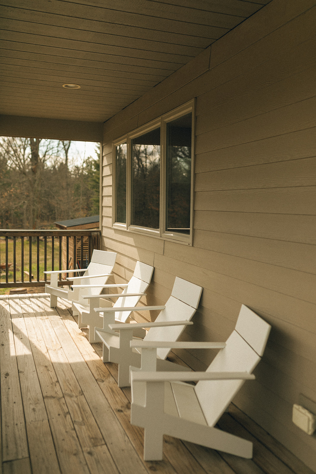 Deck with Adirondack chairs with a great view of our wooded acreage