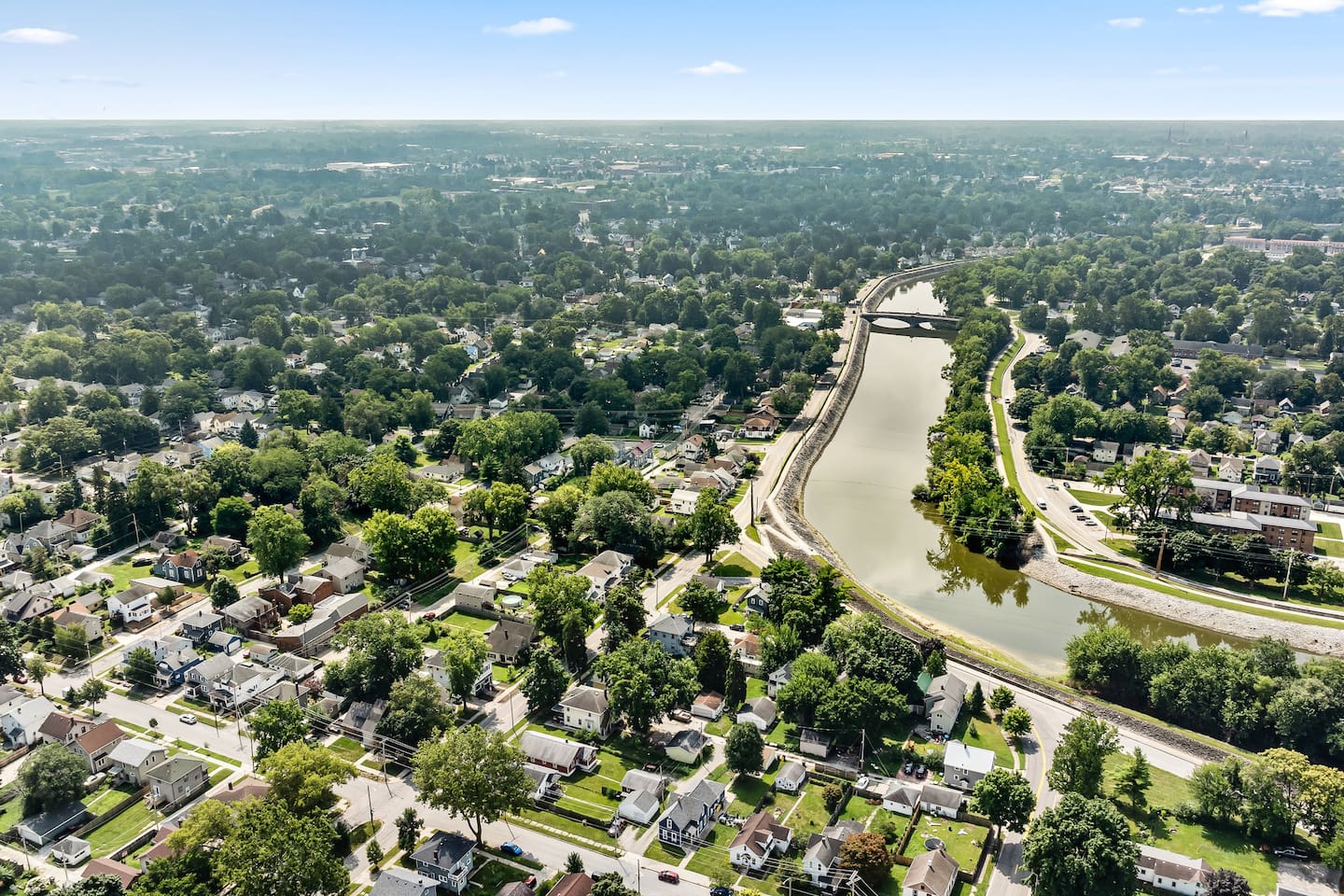 A bird's-eye look at the surrounding neighborhood, with a winding river and easy access to local streets.