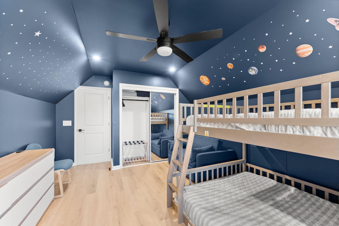 Perfect kids’ room with a space-themed blue design, full-over-queen bunk bed, and a sleeping chair—sleeps up to 4 astronauts.
