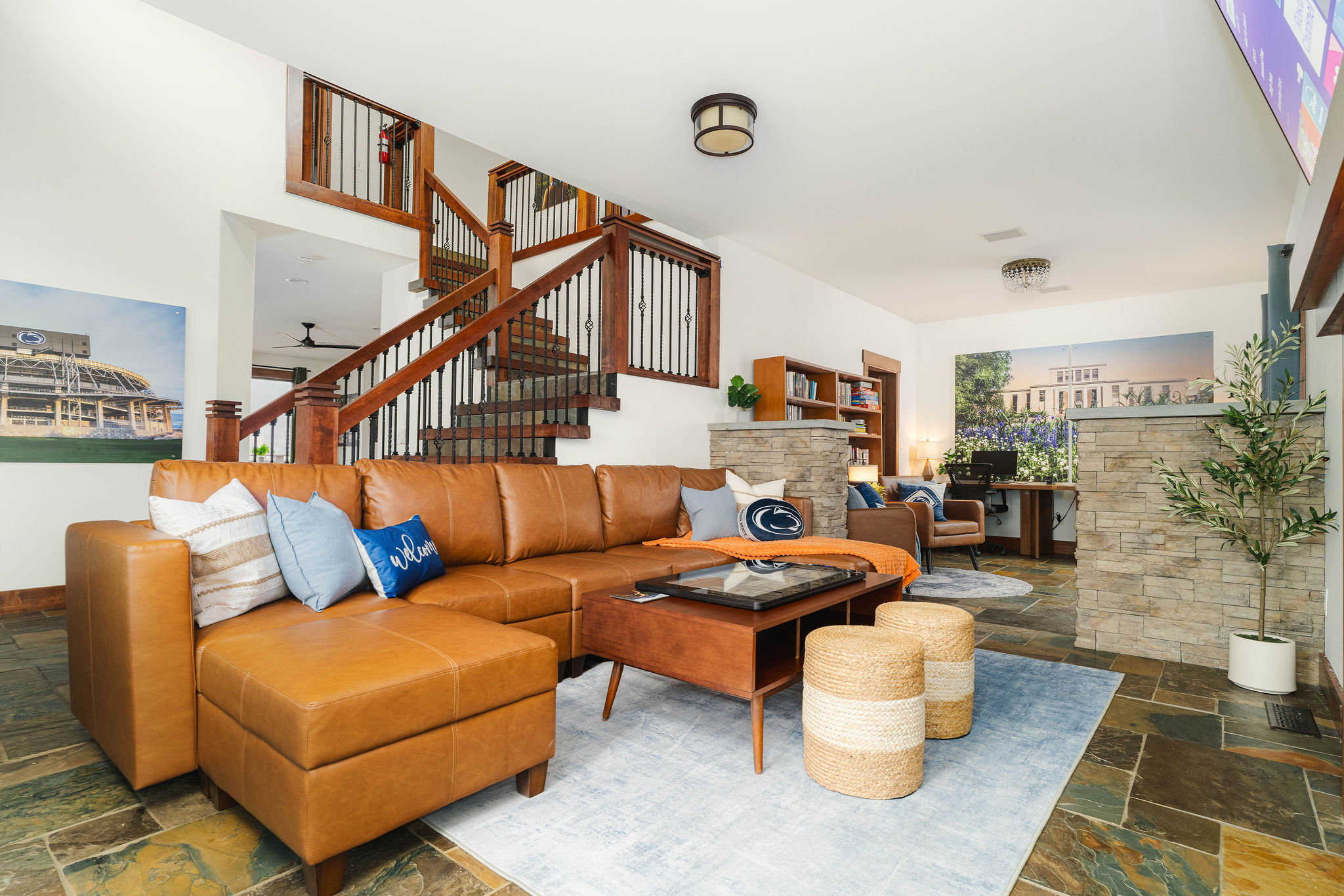 A cozy secondary lounge with books and seating — a quiet retreat just off the main living space.