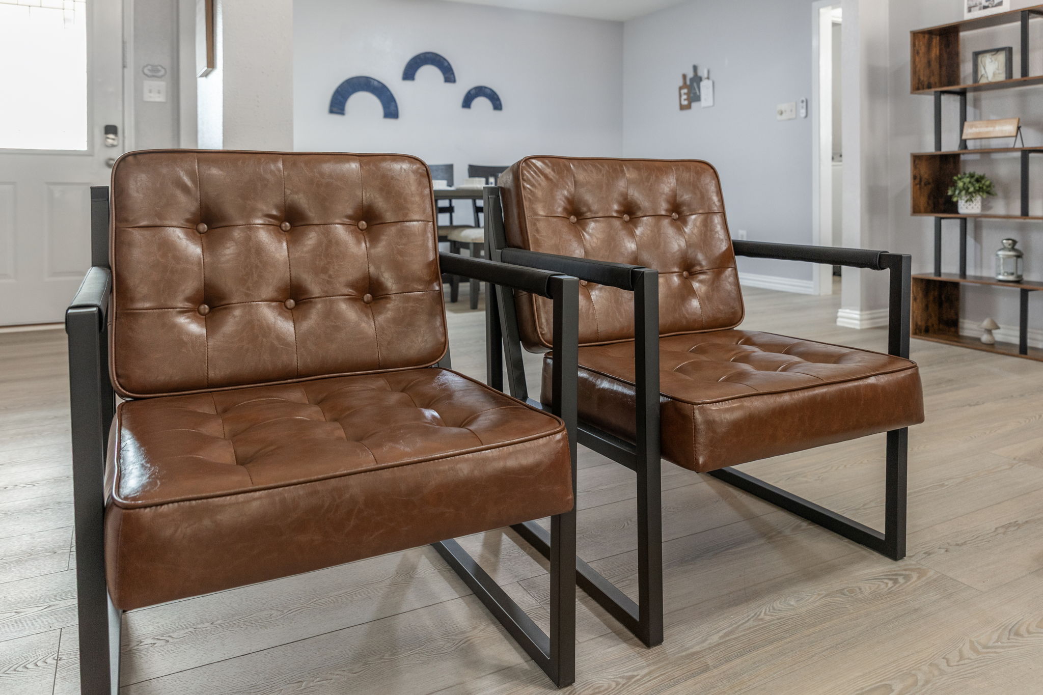 Stylish leather accent chairs in the living area for extra seating and comfort
