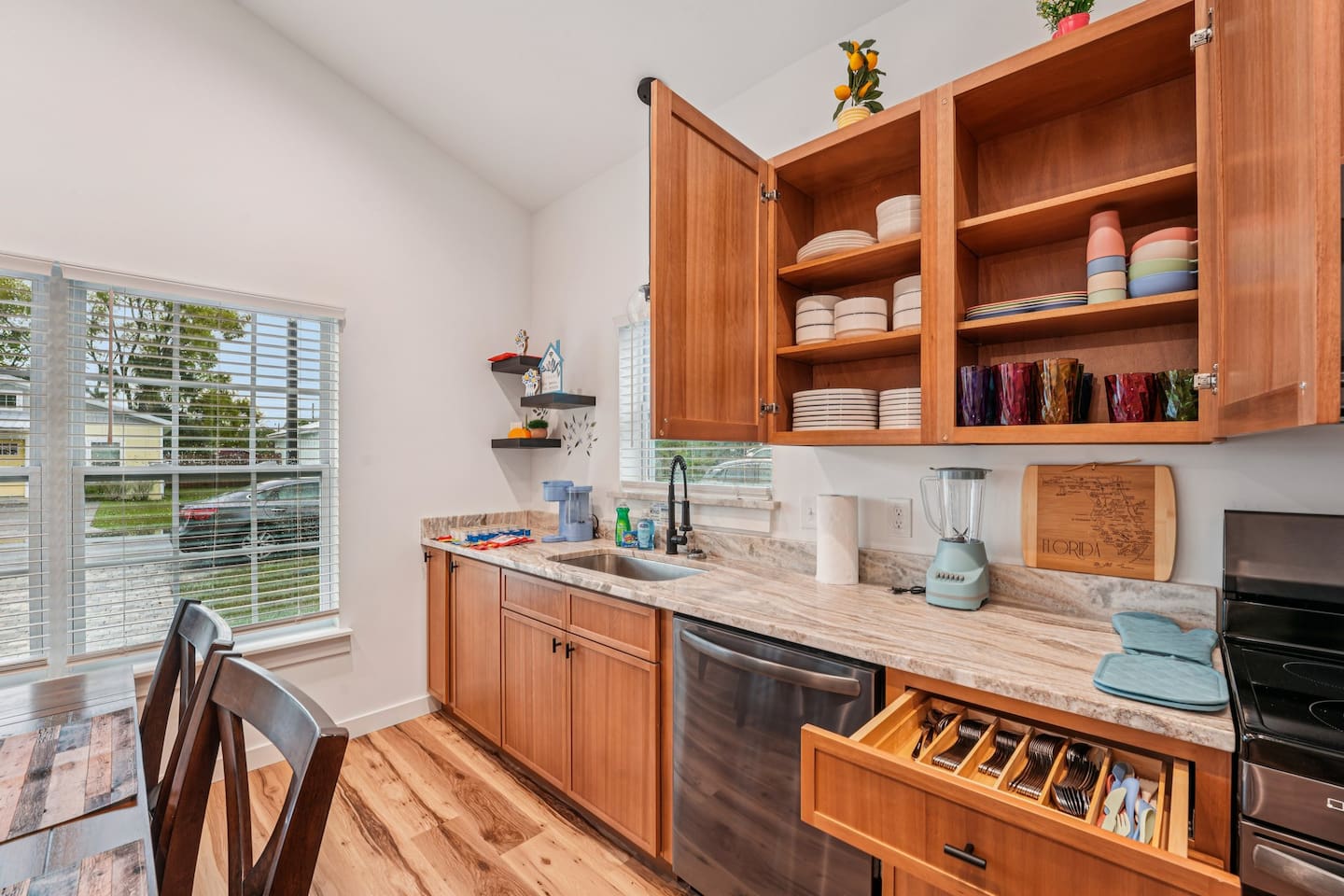 12 sets of plates, bowls, cutlery, drinkware, and a set of 4 children's dinnerware, along with a blender, keurig and plenty of pods and creamer