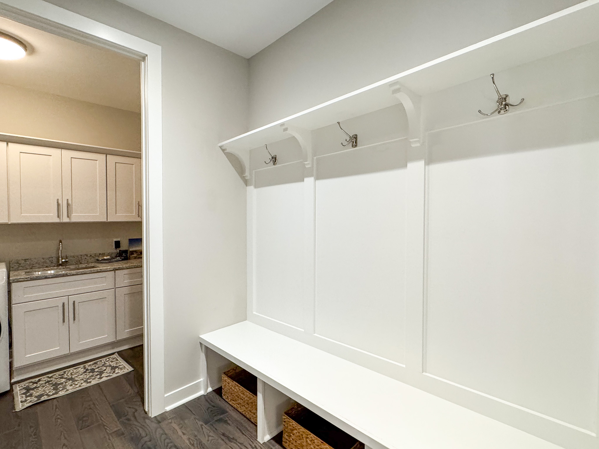 Mud room area for hanging coats and storing outdoor gear.