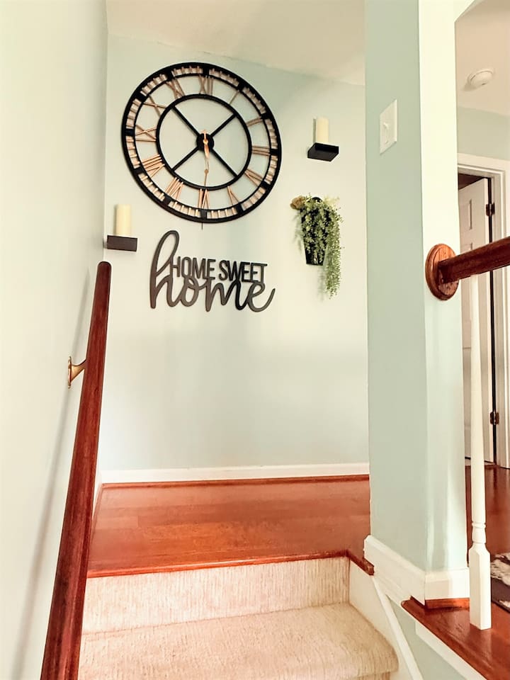 Warm wood stairs and soft walls connect upper and lower levels with ease and style. 