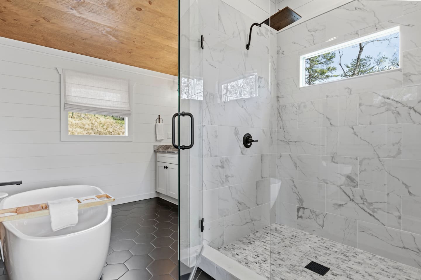 Unwind in this extra large walk in shower! The view of the trees is magical!