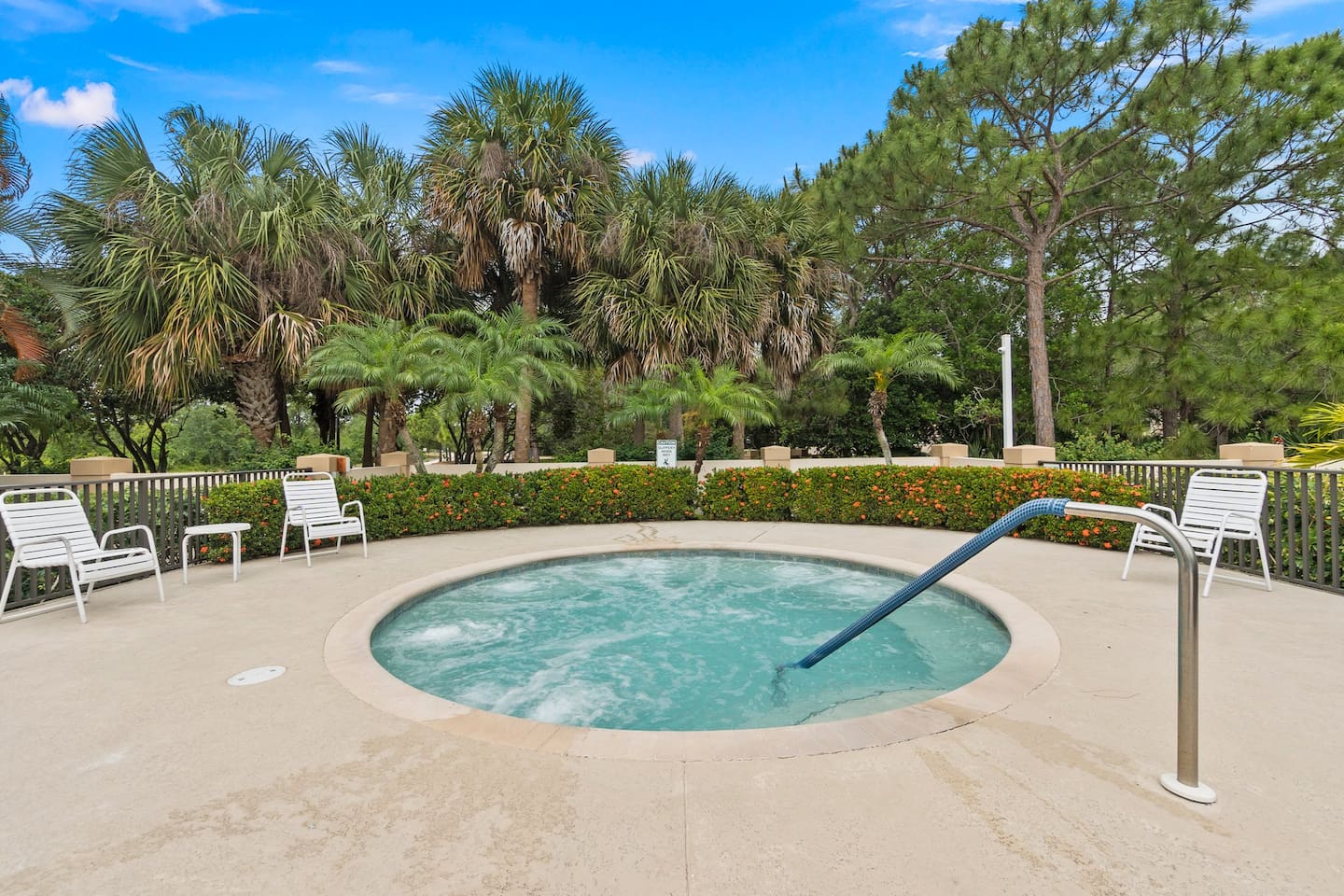 Community spa area surrounded by tropical landscaping, perfect for relaxing and unwinding.