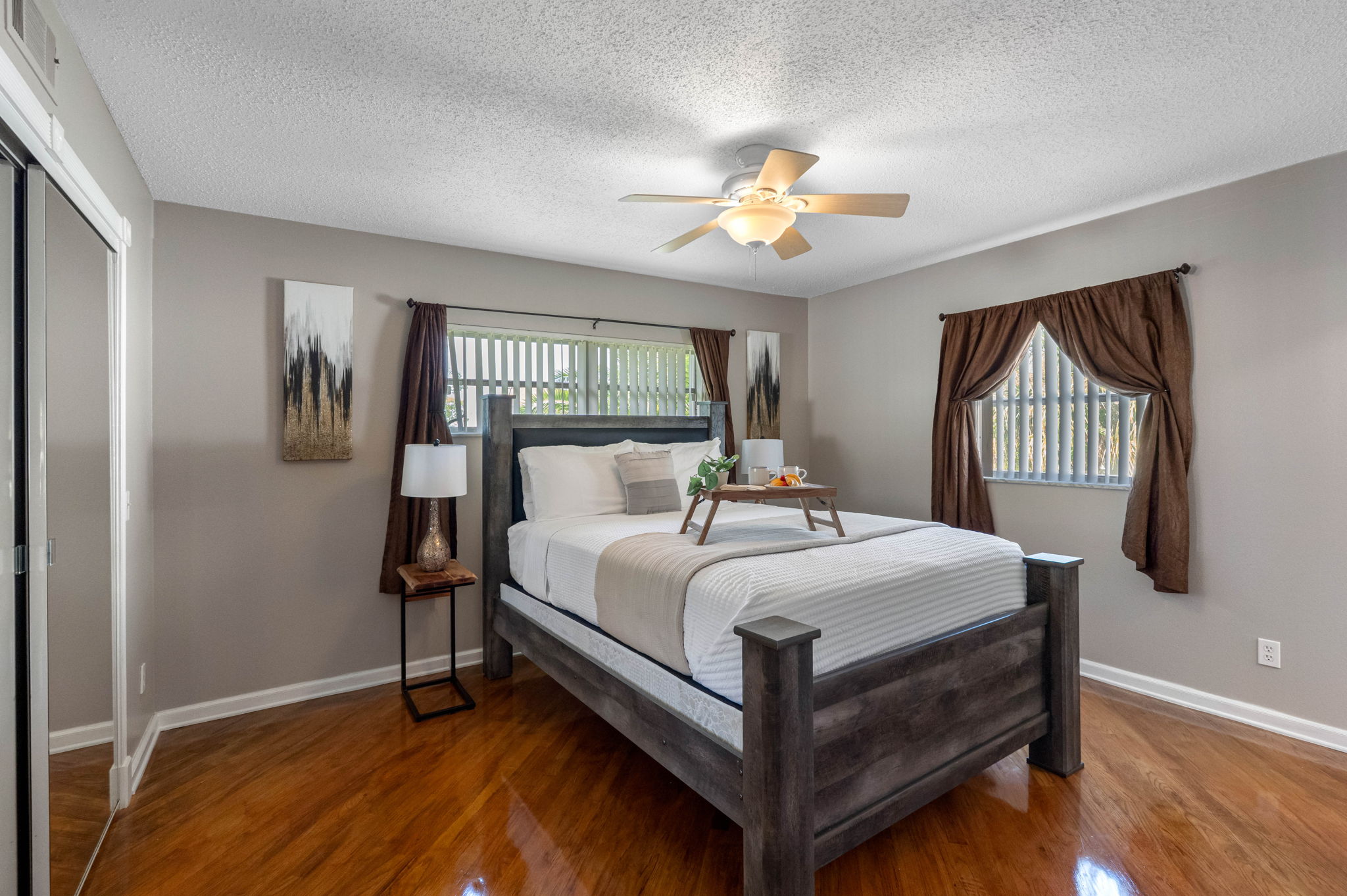 Complete with matching nightstands, dresser, and built-in lighting on the headboard, this bedroom combines function with comfort.