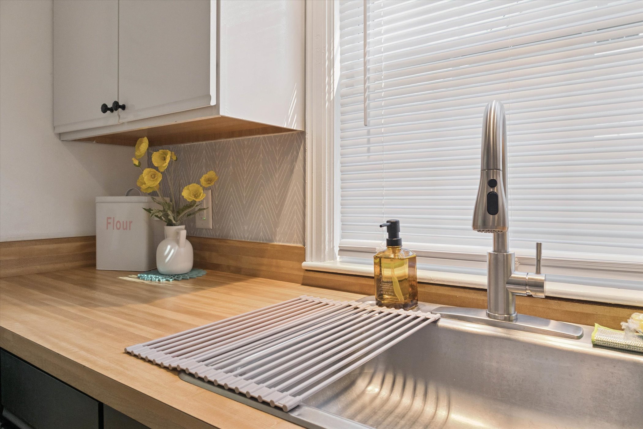 Clean, stocked, and ready to prep—our South Bend kitchen sink features a fresh wrapped sponge, a flour bin for backyard pizza nights, and ample counter space for family-style cooking.