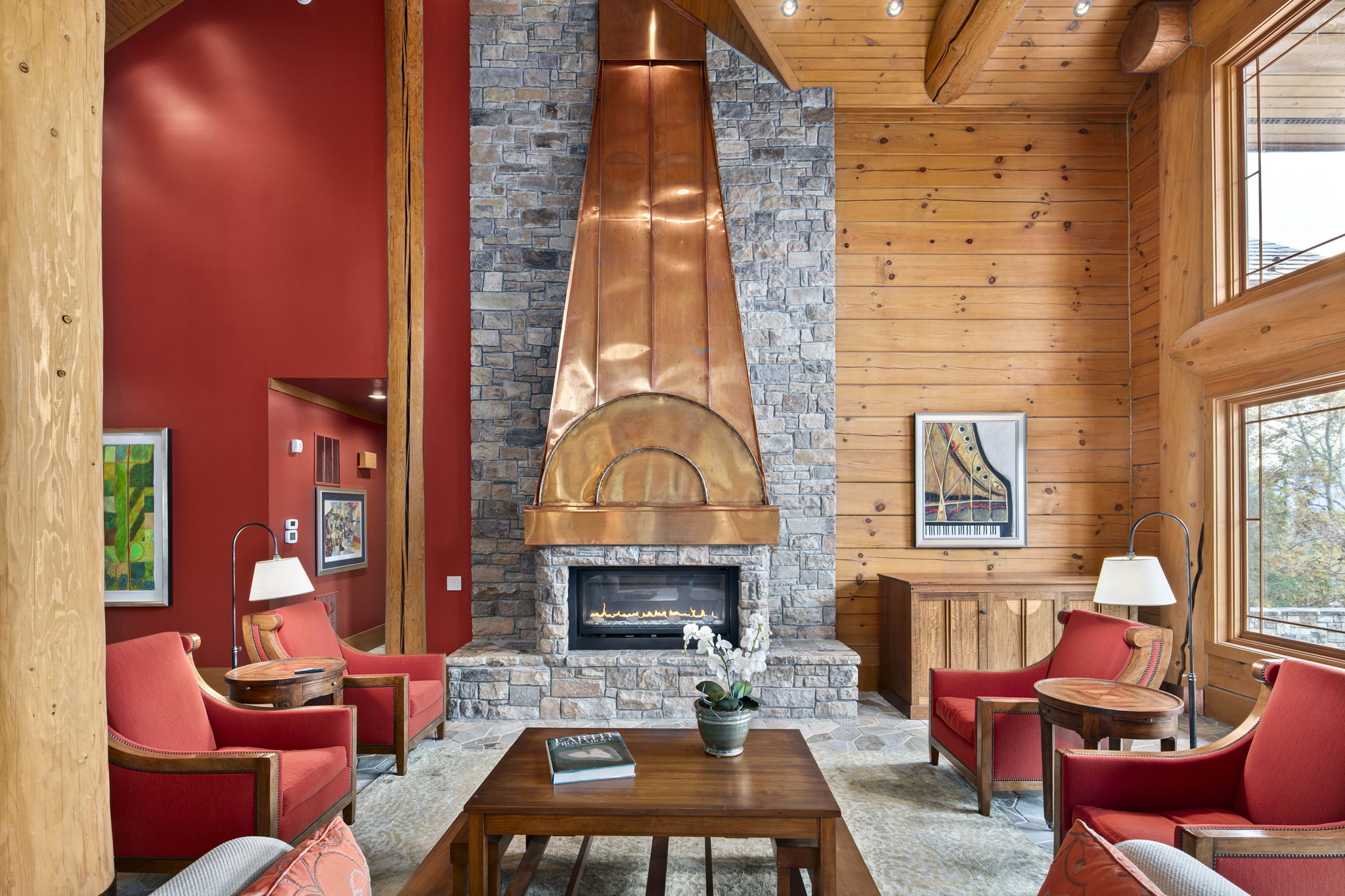 Large airy living room with fireplace, copper chimney and warm light from the back yard