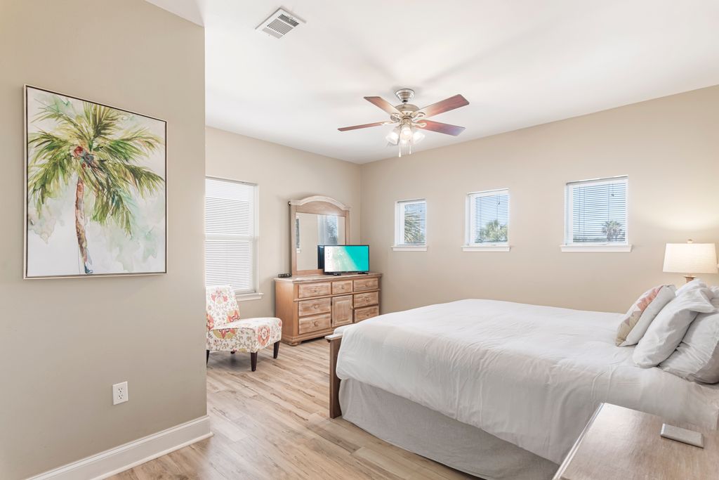 Second Floor: Bedroom 2 – Relaxing coastal-themed bedroom with nightstand, dresser, and TV for comfort.
