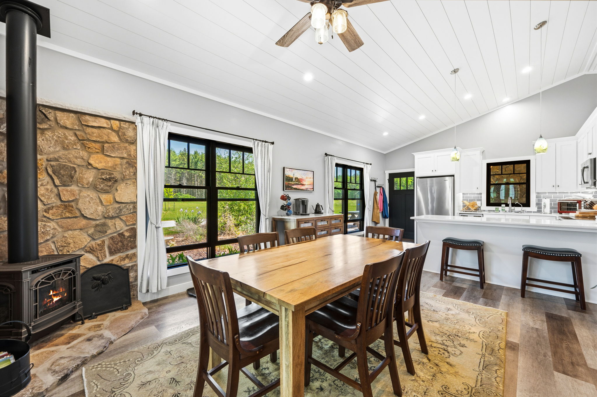 Cozy up beside the glowing gas fireplace in the dining area, seamlessly open to the kitchen and breakfast bar.