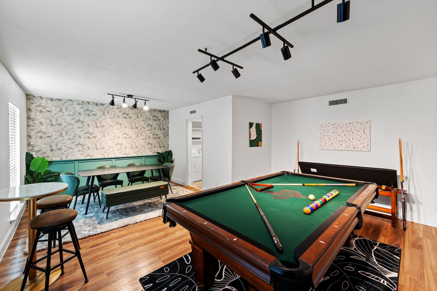 Host game night or dinner with ease in this spacious game room featuring a full pool table and a dining table for six.
