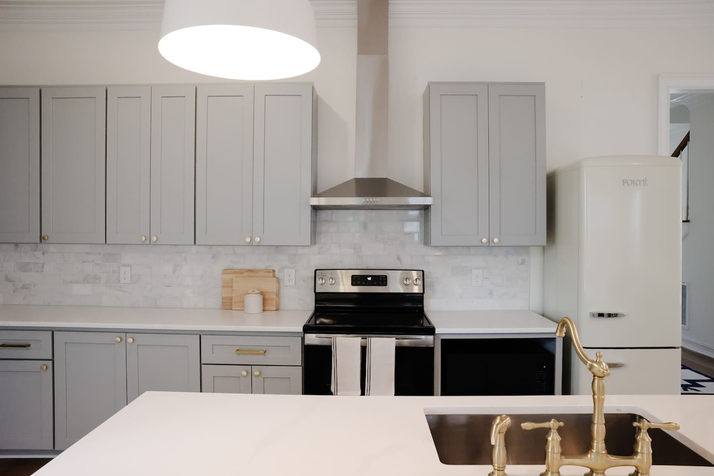 Lots of counter and cabinet space make for easy entertaining. The kitchen comes complete with stovetop, oven, microwave, fridge, freezer, and Keurig coffee maker. 