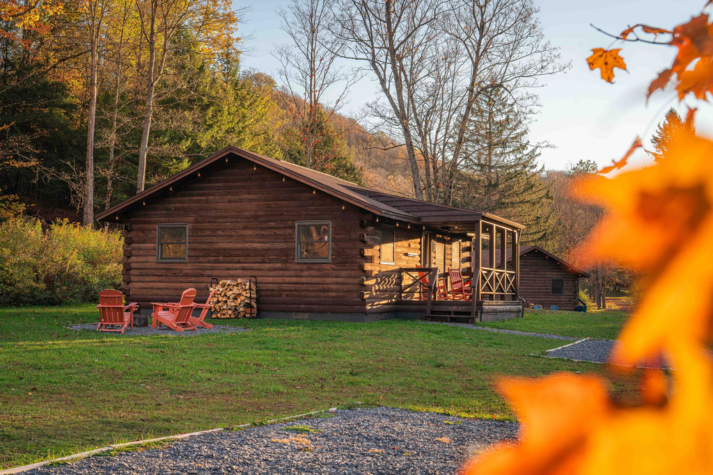 Relax on the porch or gather by the fire pit — this cozy log cabin is the perfect woodland retreat.