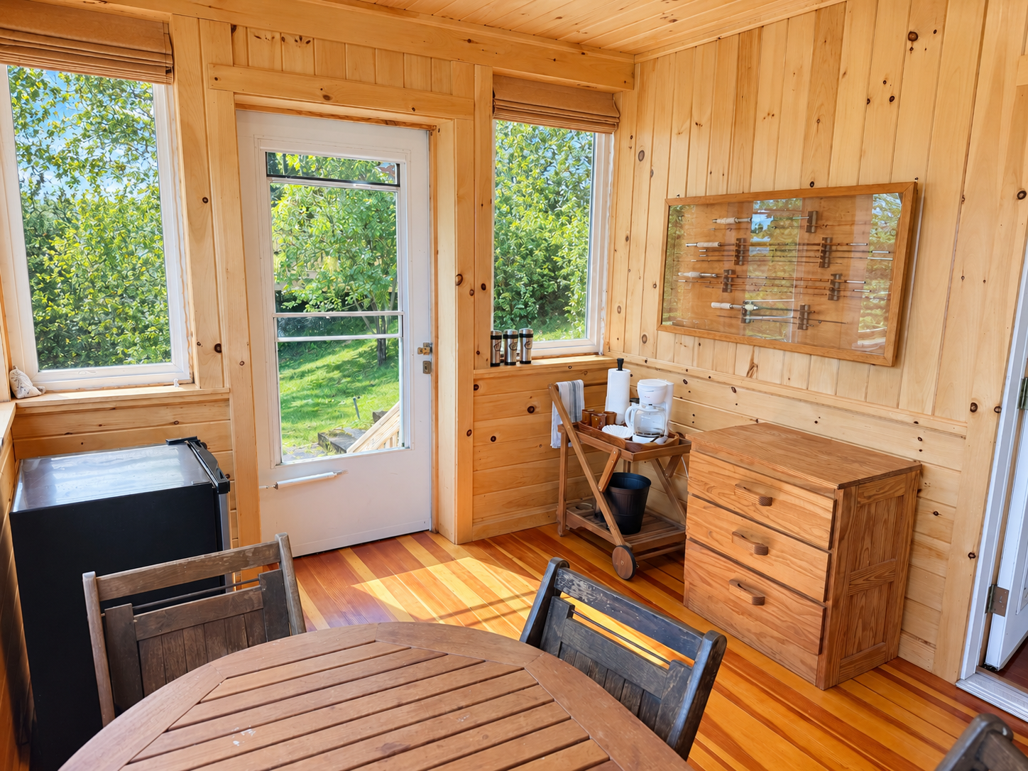 Dining area on sleeping porch with mini fridge and coffee station