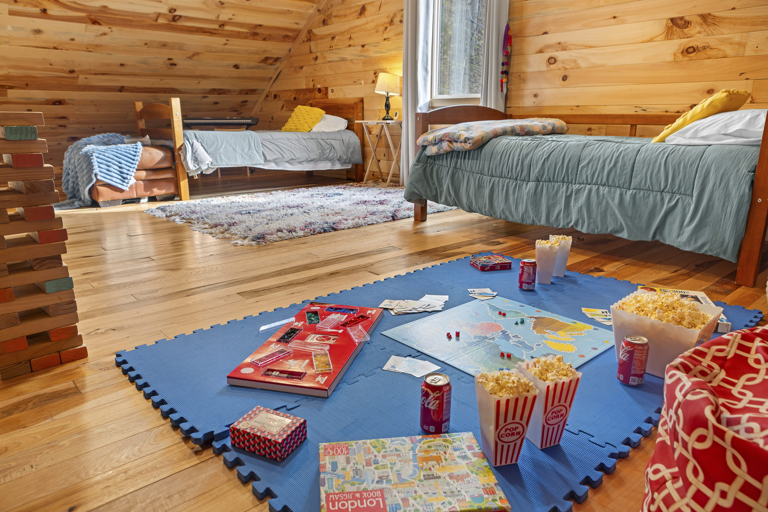 Loft Bedroom 4: Game nights await in this vibrant playroom with fun decor and comfy beds!